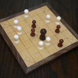 A game of brandub in progress on the Deluxe 13-piece Hnefatafl Game