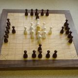 Compact 11x11 board, with reversed pieces.